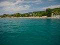 sea Ã¢â¬â¹Ã¢â¬â¹beach with resting people and beautiful aquamarine sea